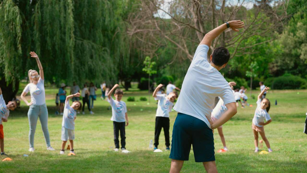 kids doing stretching exercises in the playground