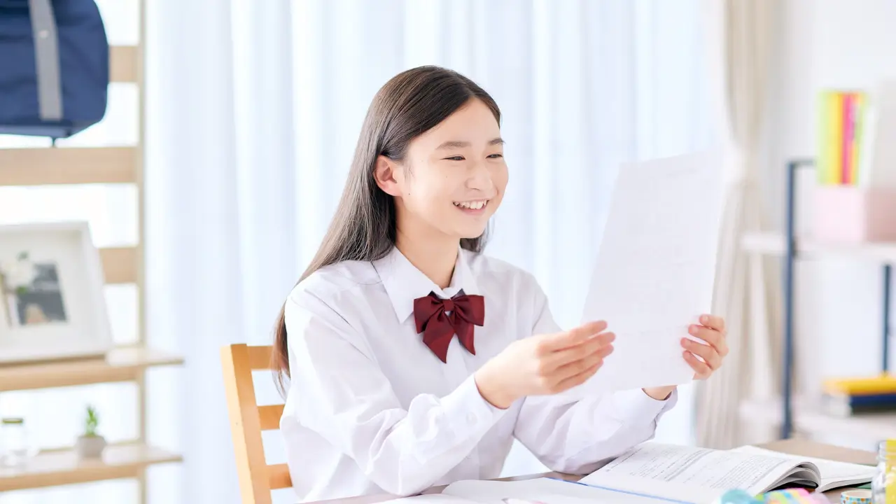 a girl happily receiving her result paper